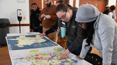 Two people looking at city plan documents