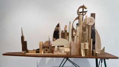 detail of mixed media sculpture composed of wooden blocks and an ironing board by Jason Lord