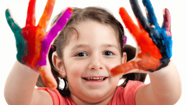 Kid with paint on their hands