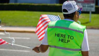 Volunteer holding American Flag