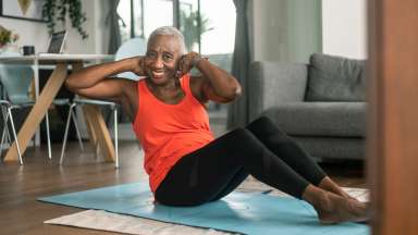 an adult doing yoga on a blue yoga mat