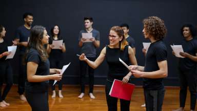 people wearing black and taking an acting class