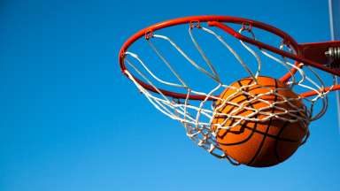 a basketball swishing through a hoop and net