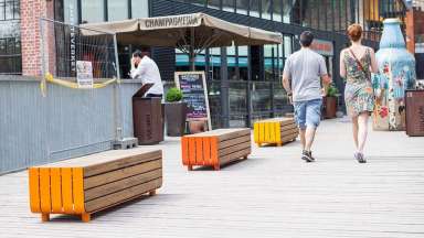 a walkway with wooden benches