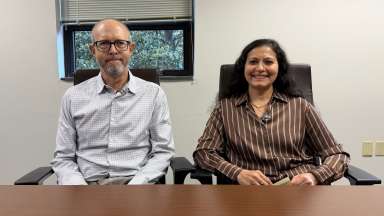 two people sitting at desk