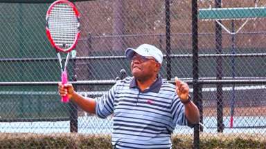 an adult playing tennis on an outdoor court