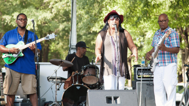 Group of individuals singing on a stage