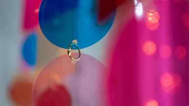 colorful glass circles connected together by a metal ring