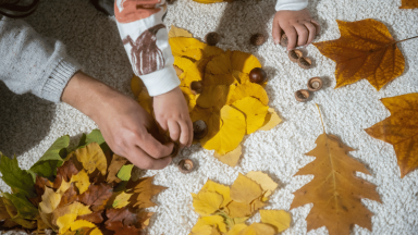 Children crafting with acorns and leaves