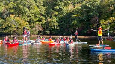 people on kayaks dressed up as witches