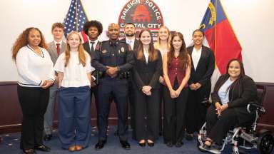 RPD interns standing with Raleigh police chief