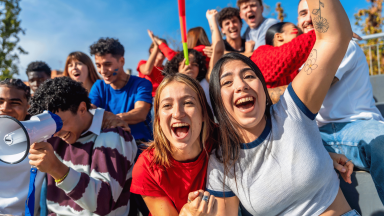 Teens cheering at a game