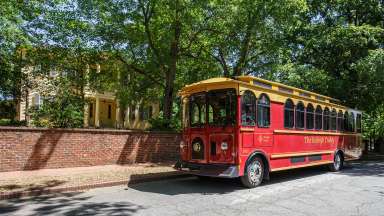 the red Raleigh trolley on the road in front of the Mordecai house
