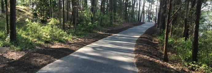 Paved greenway trail with trees
