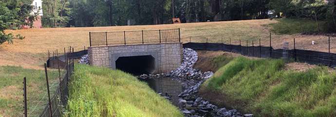 The concrete, rectangular box culvert on Knights Way that carries stormwater through the neighborhood.