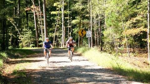 Two men on bicycles riding down a trail at Forest Ridge Park