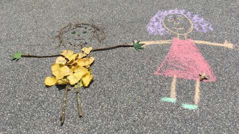 Sidewalk chalk drawing of two children