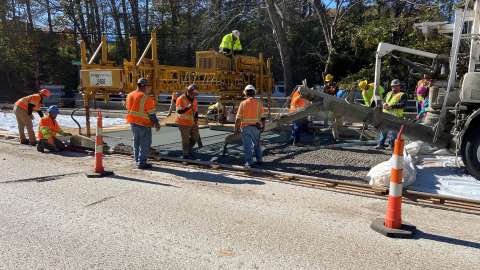 Workers pouring concrete