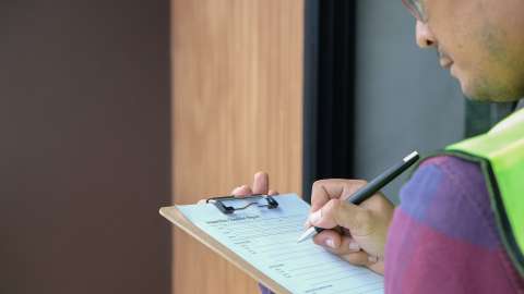 home inspector holding clipboard and pencil