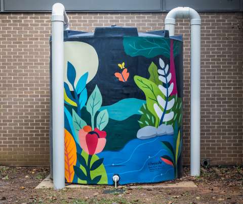 A cistern painted with brightly colored plants.