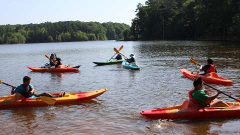 a group of teens enjoying kayaking