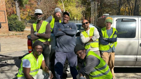 The Great Raleigh Cleanup Executive Director and six workers pose in front of a truck. 