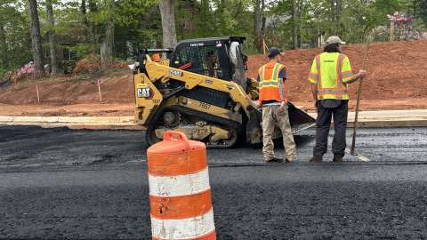 contractors paving road.