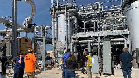 Group of people talking on a tour of the bioenergy facility
