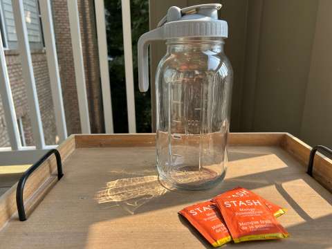 tray holding glass bar and tea bags sitting next to it