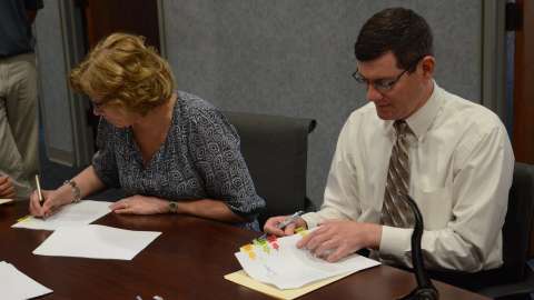 The signing of the contracts transferring ownership of Dix Park to the City of Raleigh