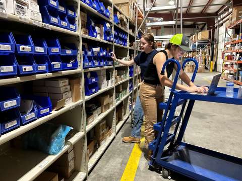 Workers in warehouse logging items