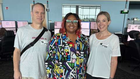 The Ingrams stand with Reid in the 911 call center.