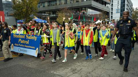 Children wearing neon yellow safety vests representing School Safety Patrols in the Raleigh Christmas Parade