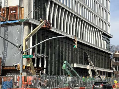 image shows installation of lower level windows and decorative fins on the outside of the new City Hall.