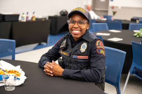 RPD officer sitting at table and smiling