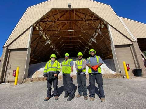 Staff in front of salt barn
