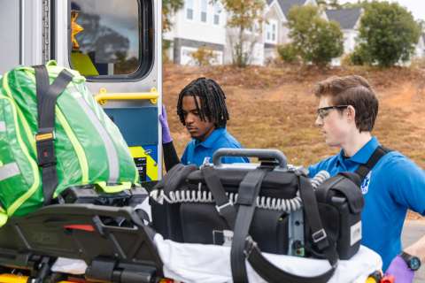 EMS First responders load stretcher into ambulance
