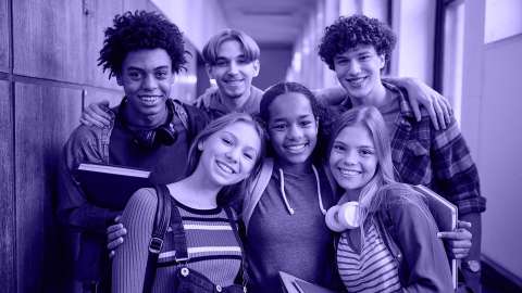 Highschool teens smiling in a hallway