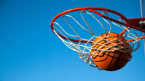 a basketball swishing through a hoop and net