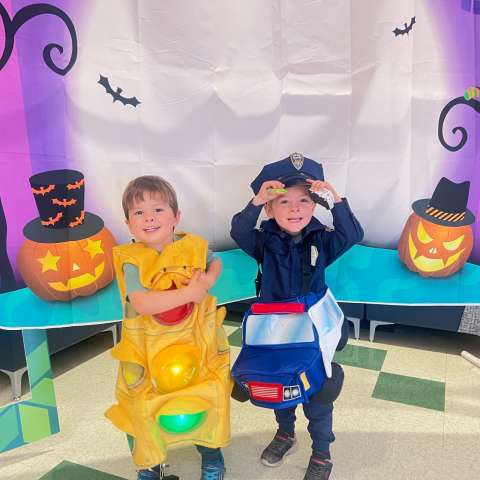 Two kids posing in Halloween costumes