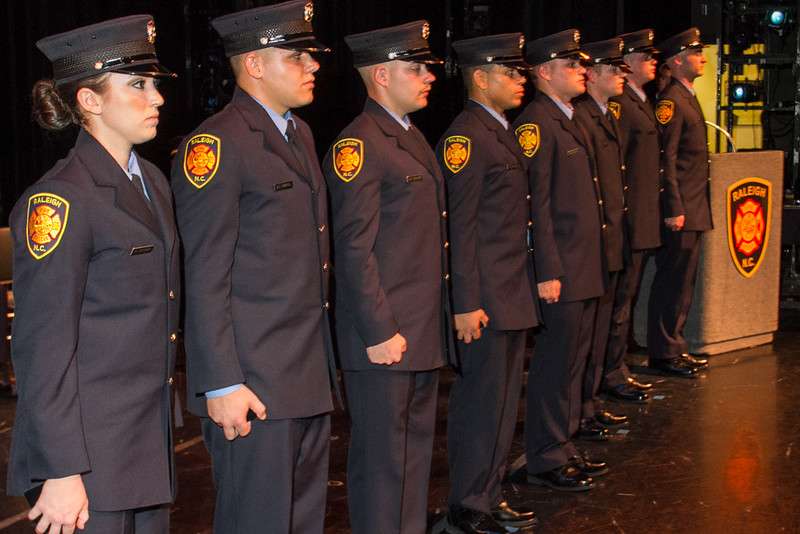 firefighters in dress uniform standing in row