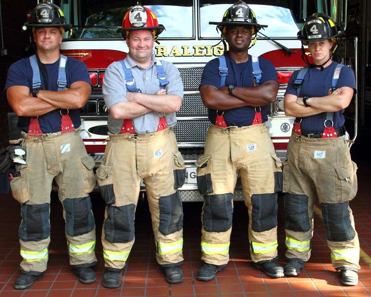 firefighters stand in front of fire engine