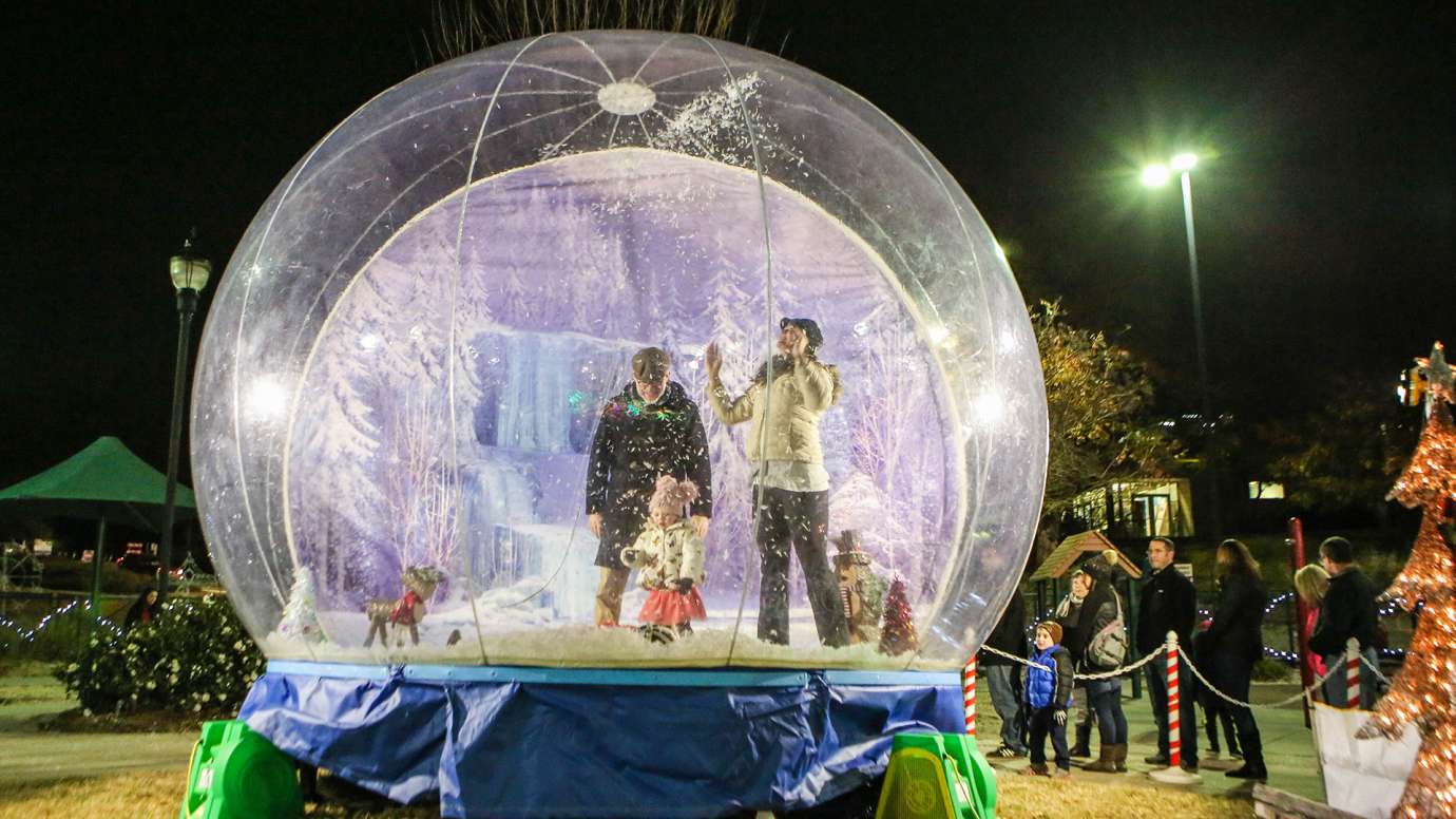 Family in an inflatable holiday snow globe.