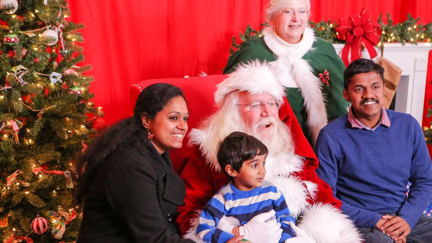Family sitting with Santa and Mrs. Clause