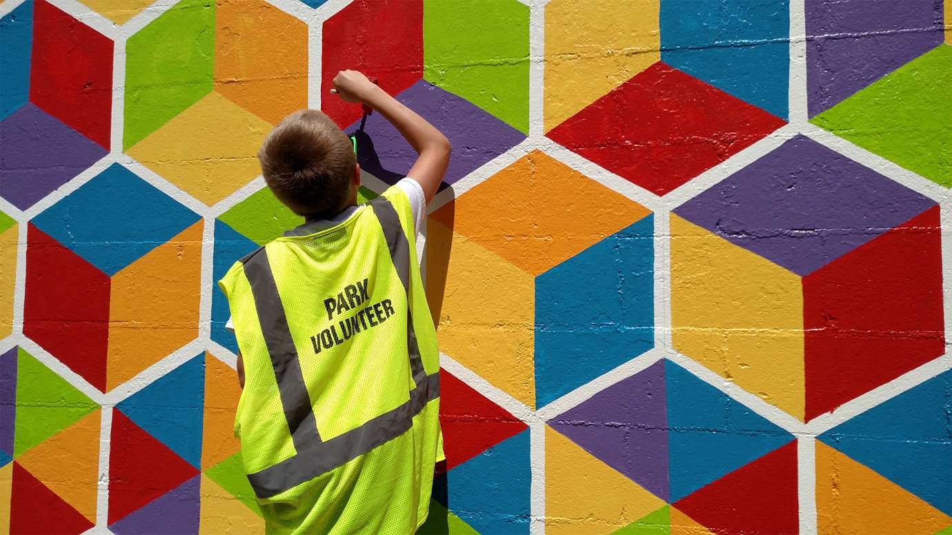 Boy painting a mural