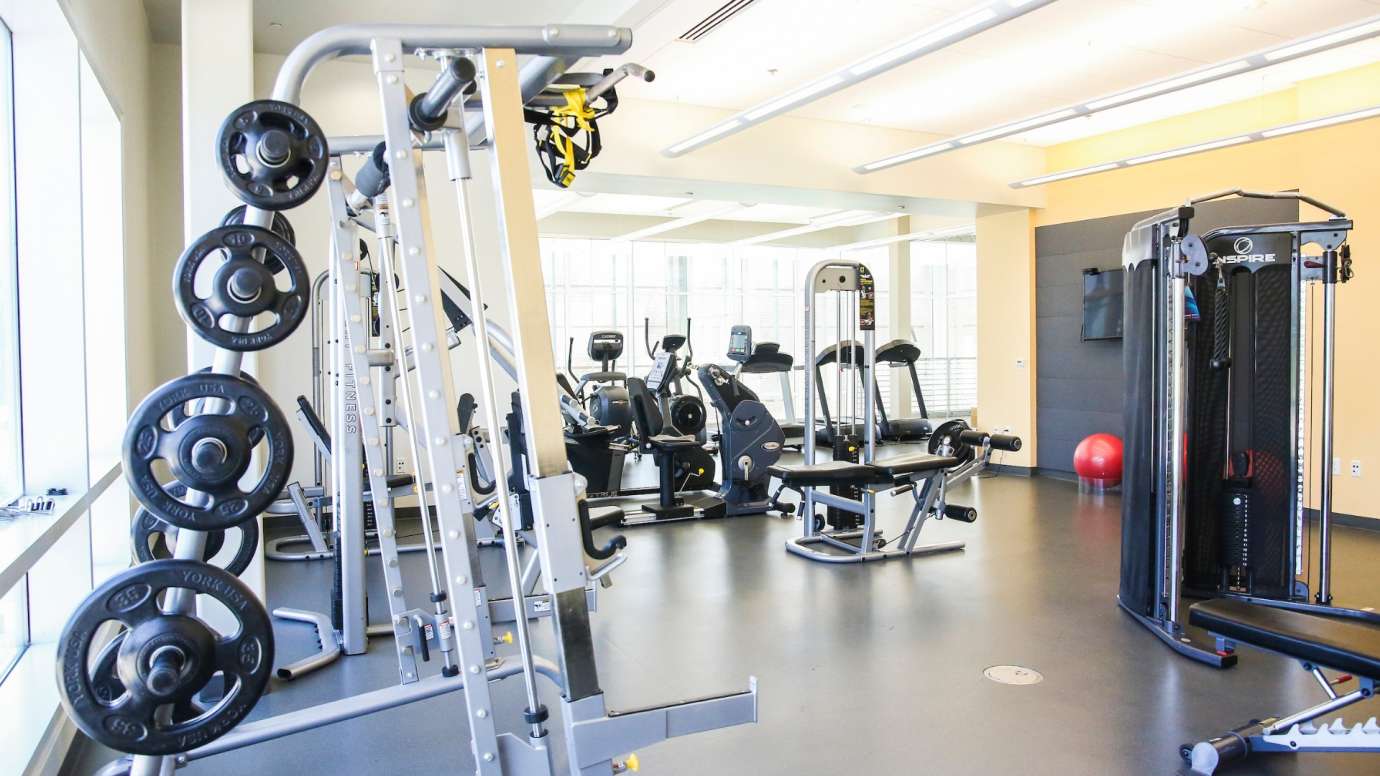 Various weight and cardio machines inside the Abbotts Creek Fitness room
