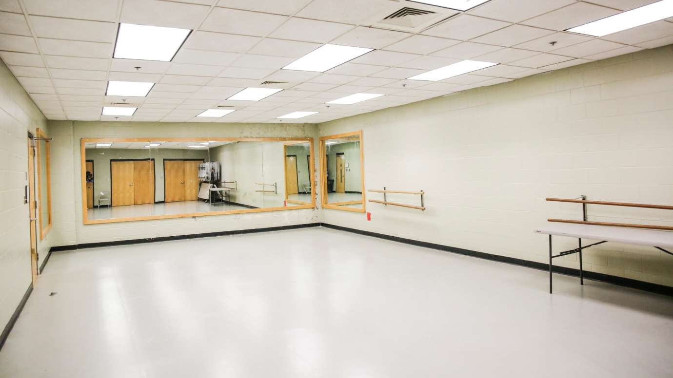 A dance studio with bars and mirrors 