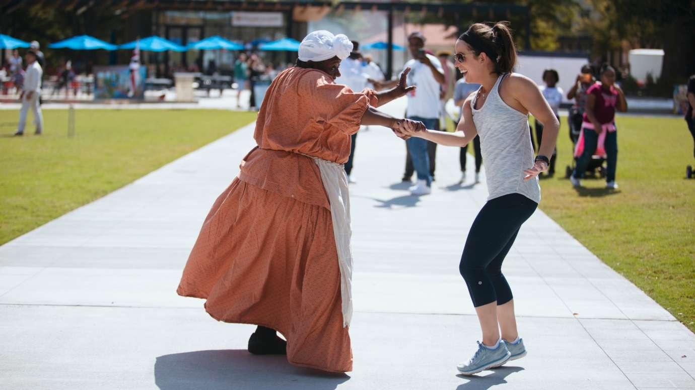 Two ladies dancing during the Raleigh Roots History Festival 