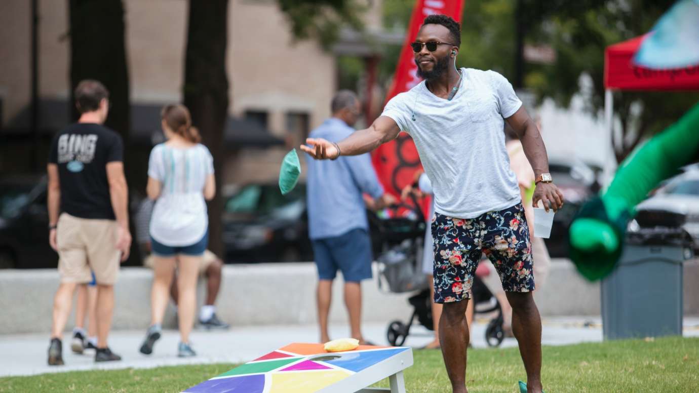 A man playing corn hole during a special event 