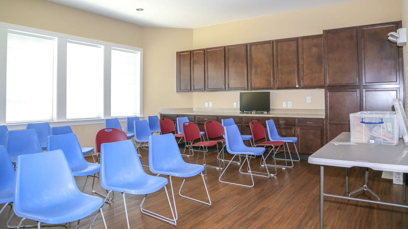 Meeting room with multiple chairs and counter space 
